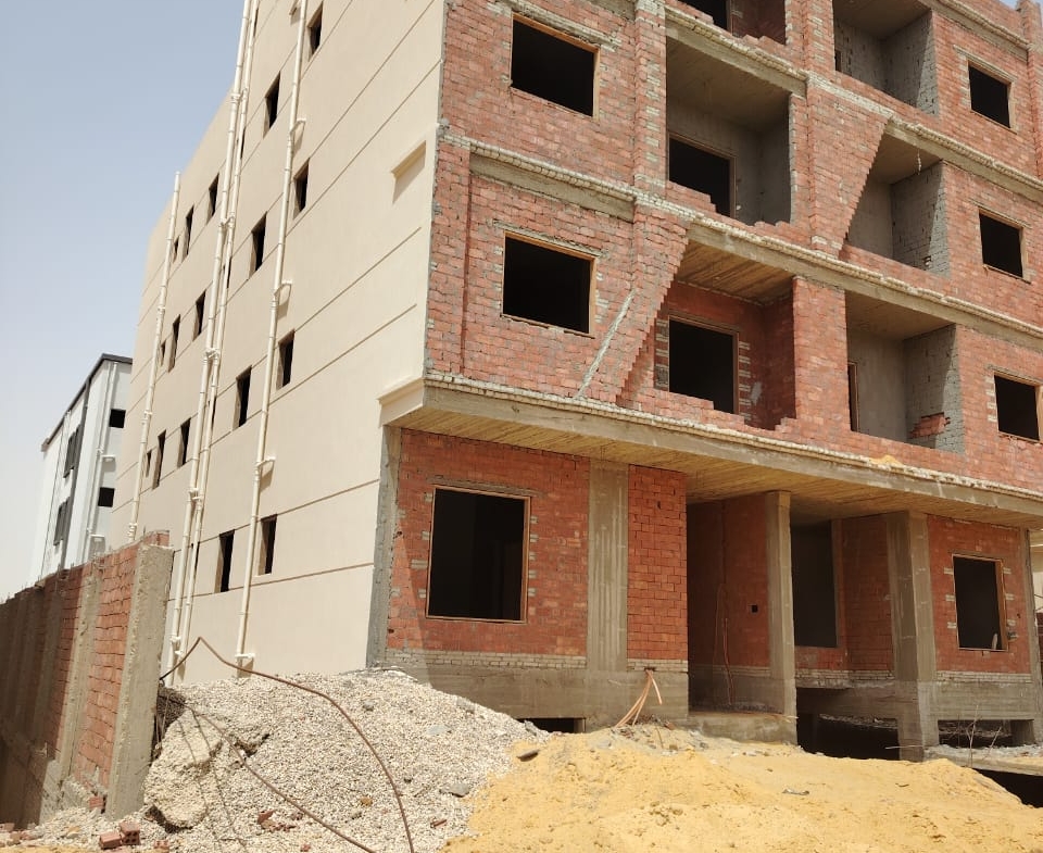 Apartment building shell with brick and plaster on a sandy lot - apartment in Bayt Al Watan, New Cairo