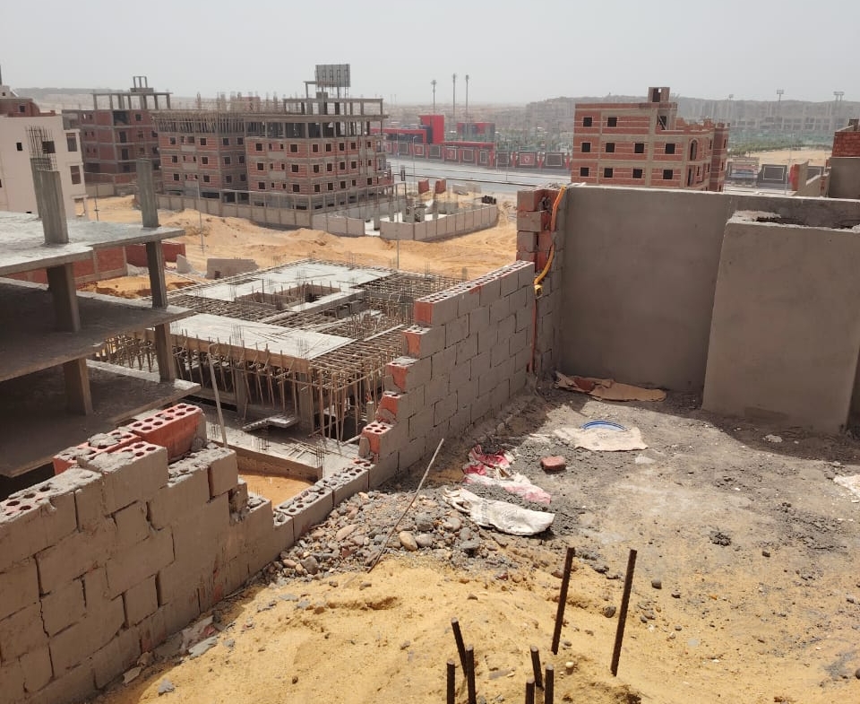 Construction site with rebar and neighbouring buildings - apartment in Bayt Al Watan, New Cairo