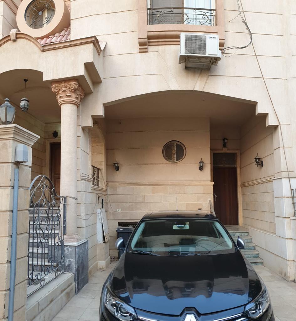 Villa entrance with columns and a parked car - villa in Maadi Heights