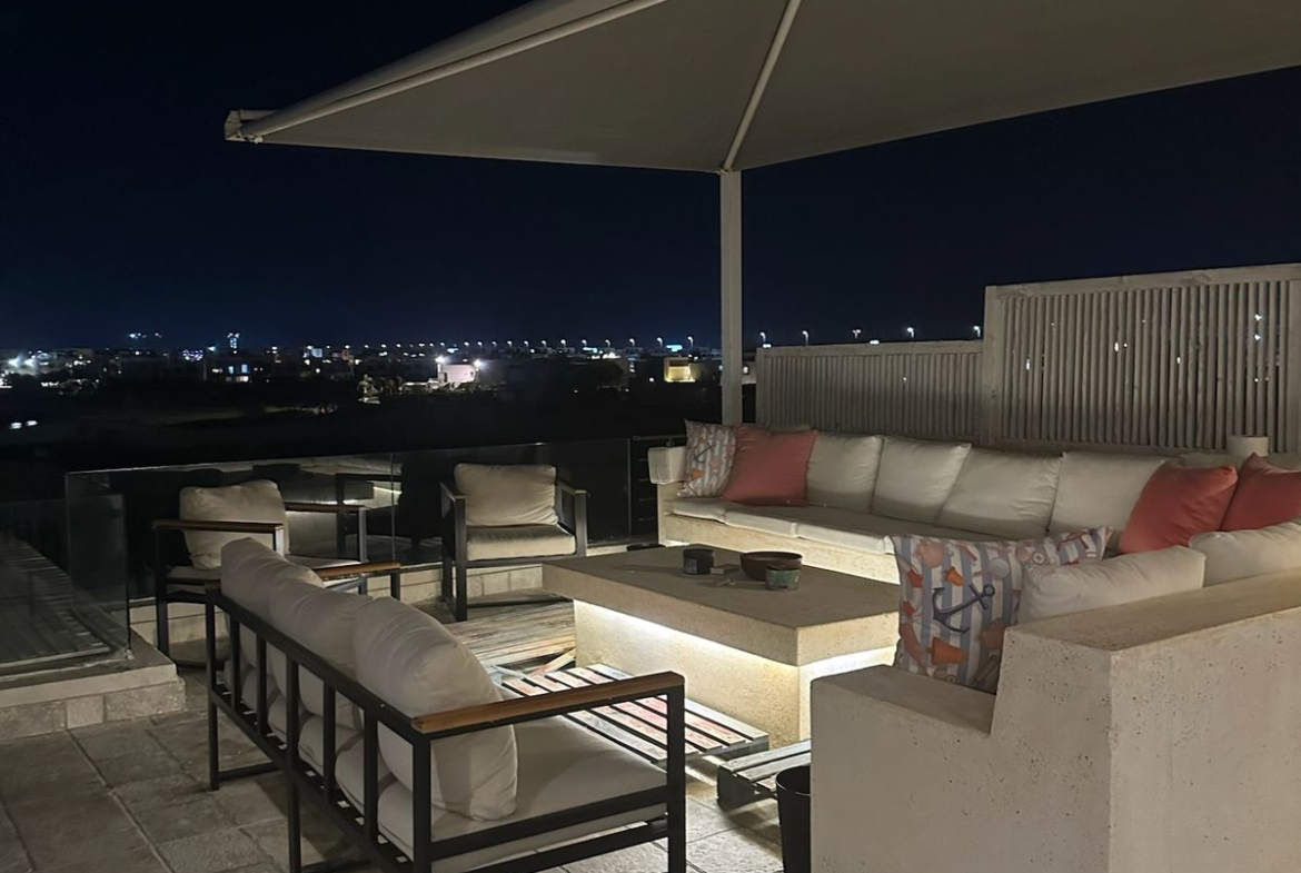 Roof lounge at night with sofas and a low table - chalet in Hacienda Bay, North Coast