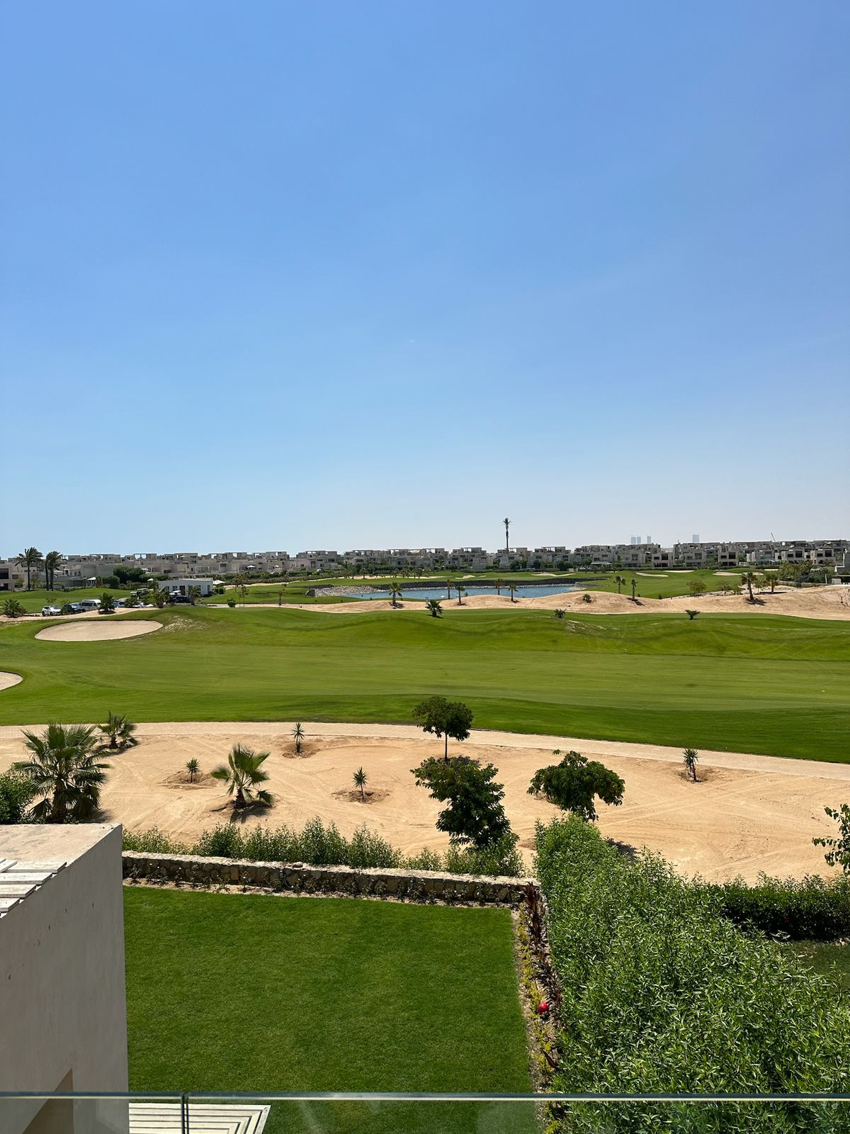 Green fairway and landscaped garden seen from the balcony - chalet in Hacienda Bay, North Coast