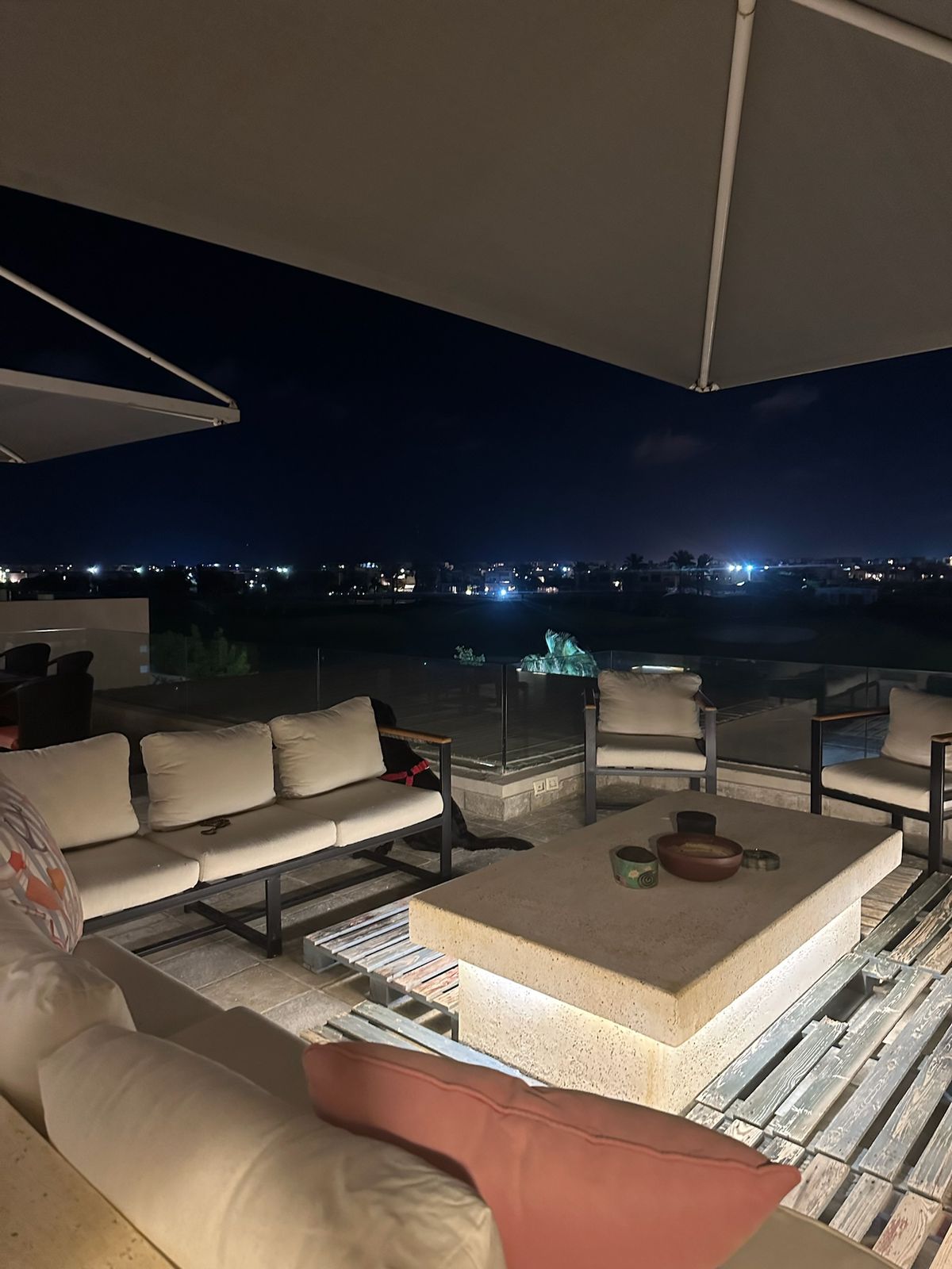 Fire-pit lounge on the roof with outdoor sofas at night - chalet in Hacienda Bay, North Coast