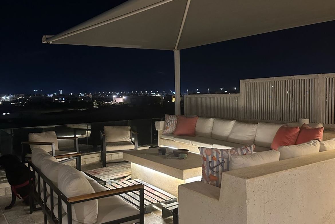 Covered roof seating area lit up at night - chalet in Hacienda Bay, North Coast