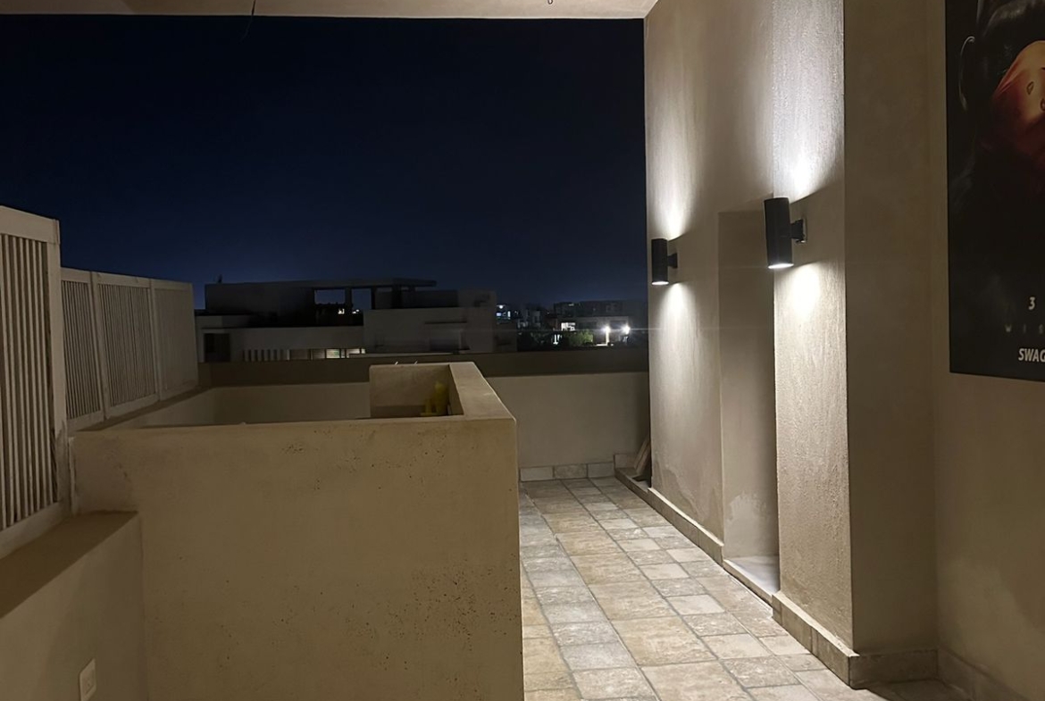 Terrace corner with wall lights and stone floor - chalet in Hacienda Bay, North Coast