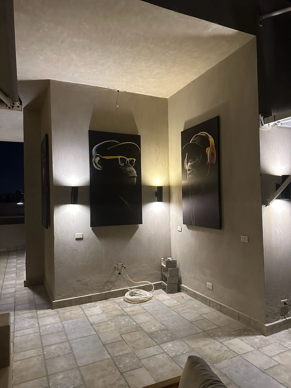 Wall-lit corner with framed art on the terrace - chalet in Hacienda Bay, North Coast