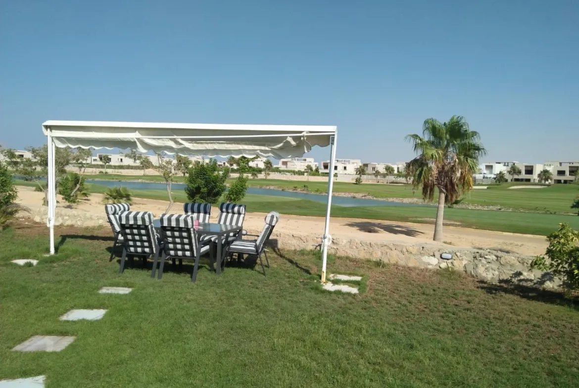 Garden dining set under a white canopy beside the golf course - chalet in Hacienda Bay, North Coast