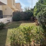 Backyard garden with lawn and trees, villa for sale in Al Rehab City