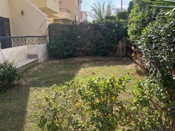 Backyard garden with lawn and trees, villa for sale in Al Rehab City