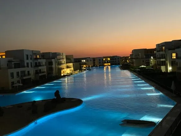 Swimming pool at sunset in Marassi, North Coast - حمام السباحة وقت الغروب في مراسي، الساحل الشمالي