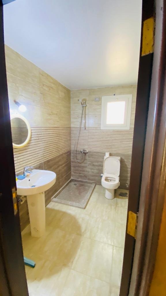 3-bedroom-chalet-for-sale-in-egypt-1 Bathroom with shower and sink in a chalet at Aroma Resort