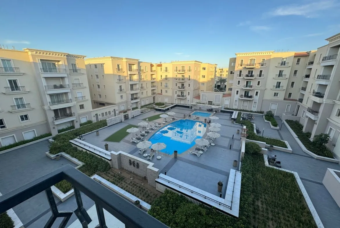 Pool and apartment buildings seen from the balcony - apartment in Mivida, New Cairo