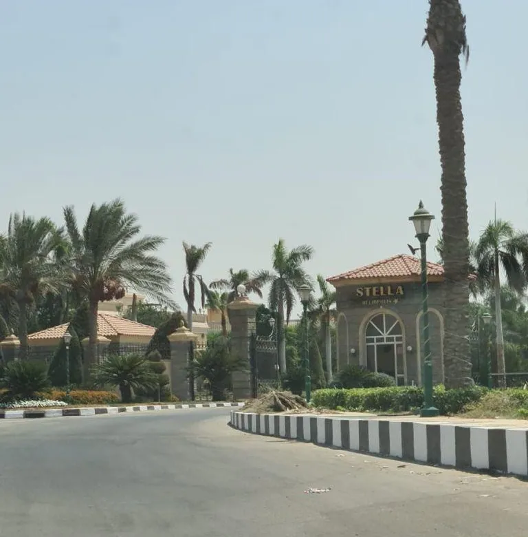 Access road with palm trees in Stella Heliopolis Compound