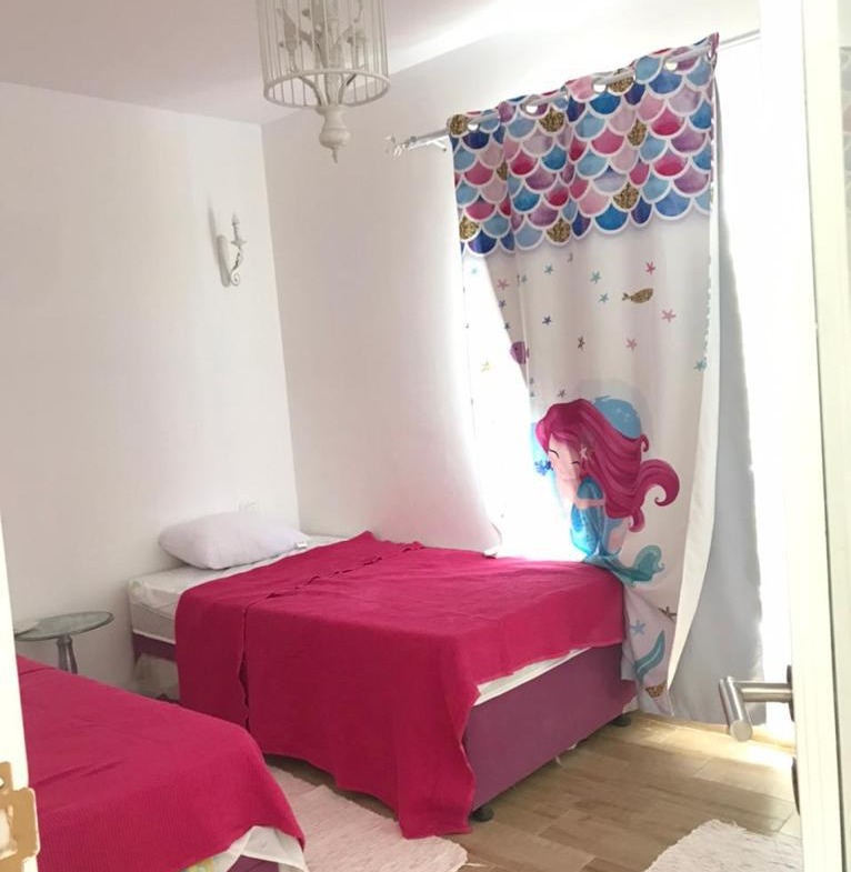 Child bedroom with pink beds and cartoon curtain - chalet in Rhodes, North Coast