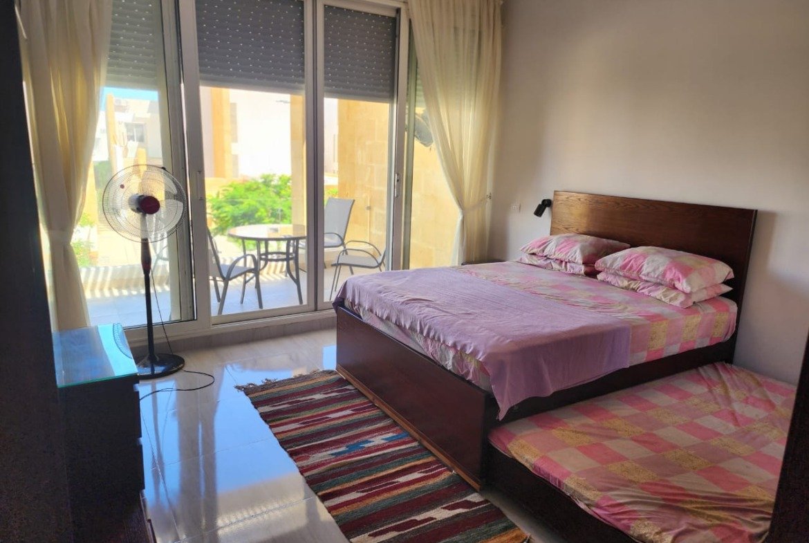 Bedroom with balcony access in the Seashell duplex, North Coast