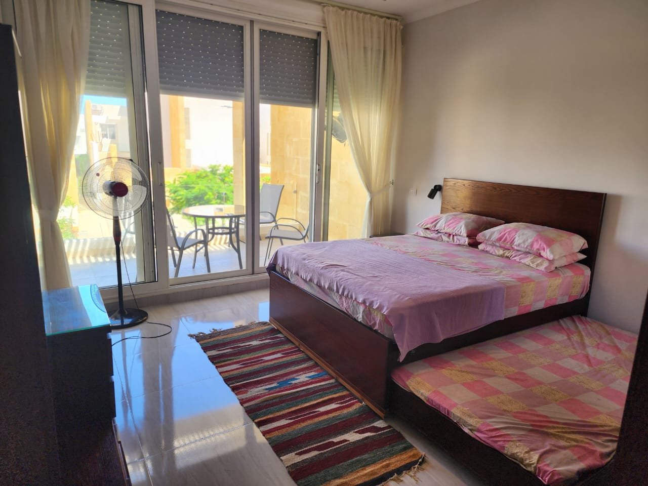 Bedroom with balcony access in the Seashell duplex, North Coast