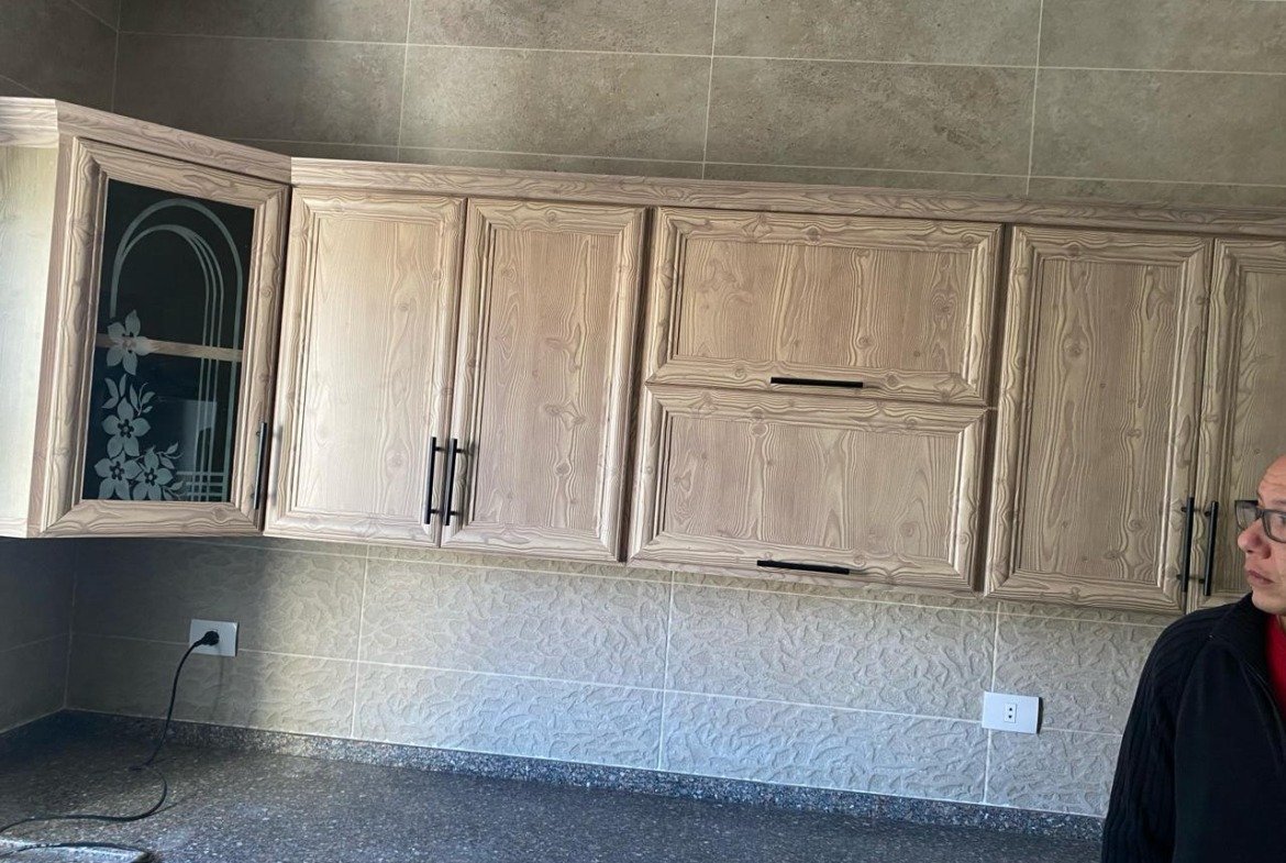 Kitchen with wooden cabinets and granite counter - apartment in Fifth Square, New Cairo