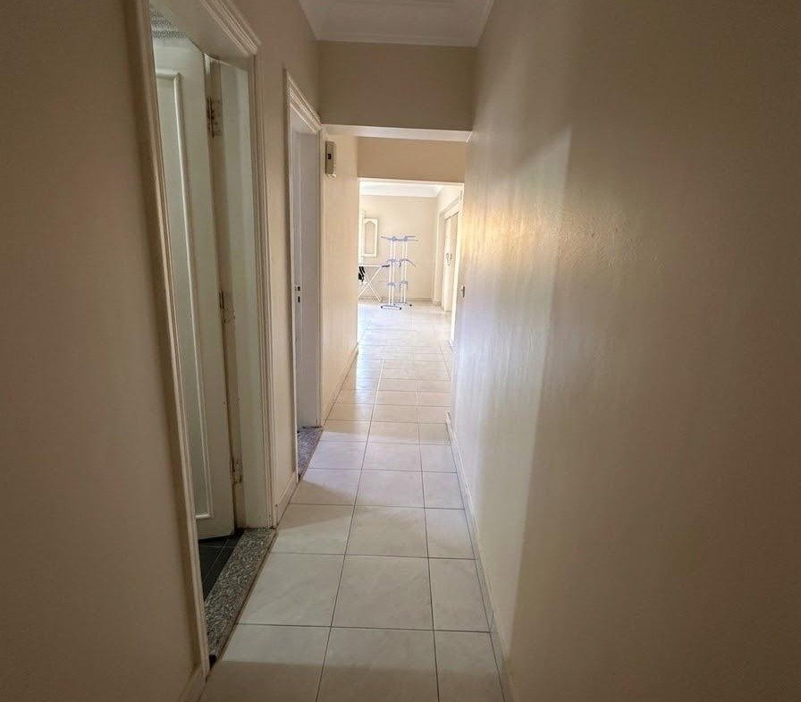 Narrow hallway with a tiled floor and light at the end - apartment in Sahafeen Compound, New Cairo