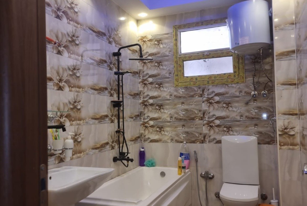 Bathroom with a bathtub and a blue ceiling light - duplex in Gardenia Heights, New Cairo