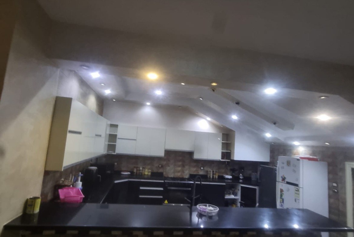 Kitchen with a black island and a patterned front - duplex in Gardenia Heights, New Cairo