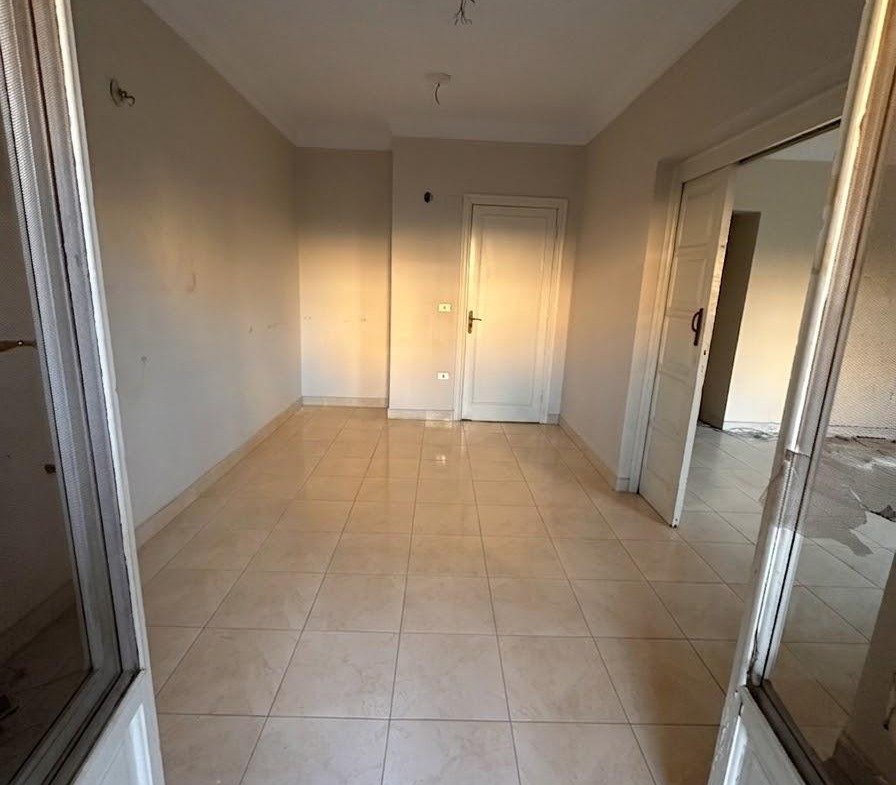 Tiled corridor leading to a door at the end - apartment in Sahafeen Compound, New Cairo