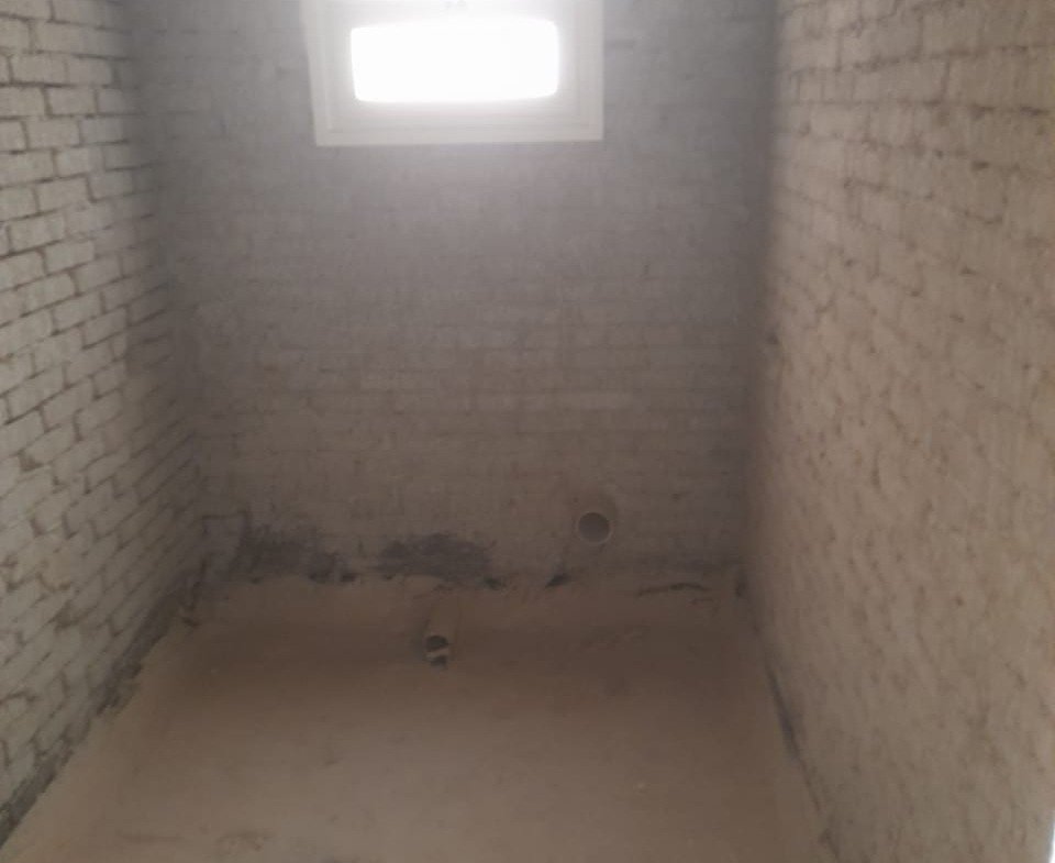 Small unfinished room with block walls and a high window - penthouse in Green House, 5th Settlement