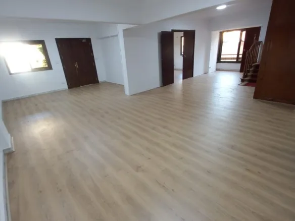Empty room with wood flooring and dark doors - unit in Marassi