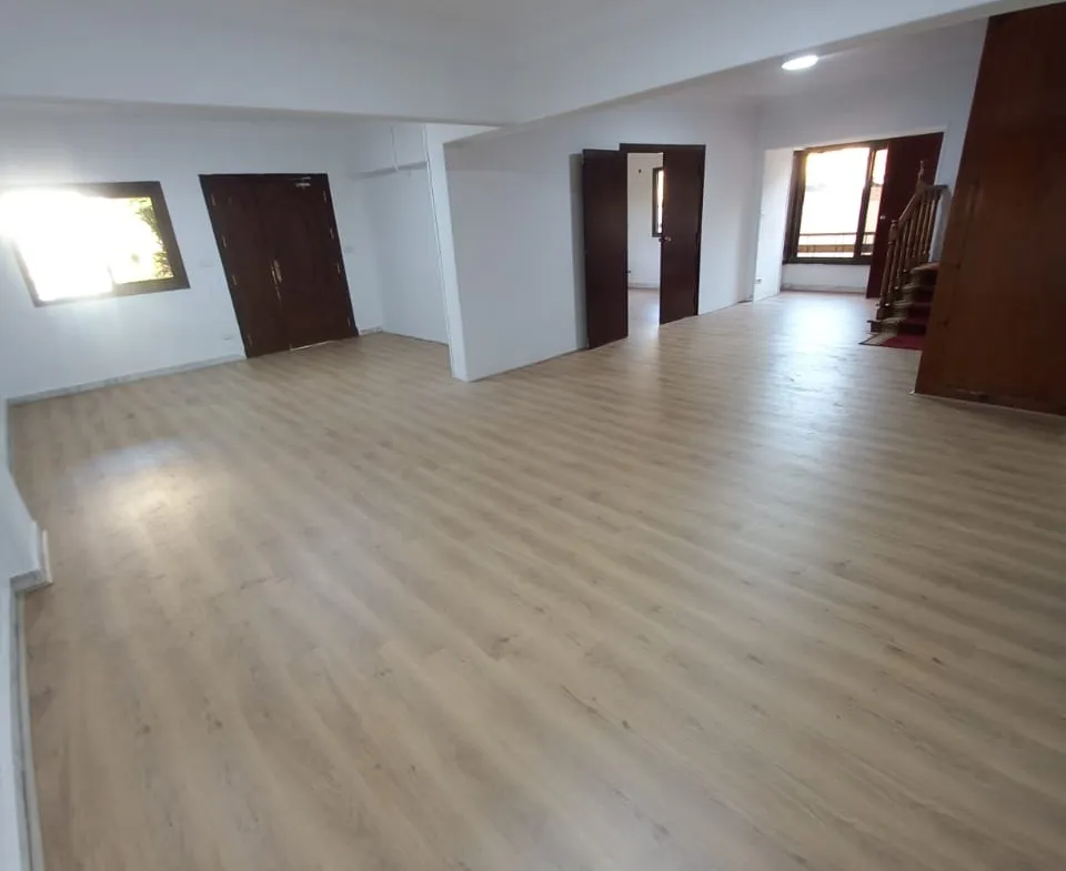 Empty room with wood flooring and dark doors - unit in Marassi