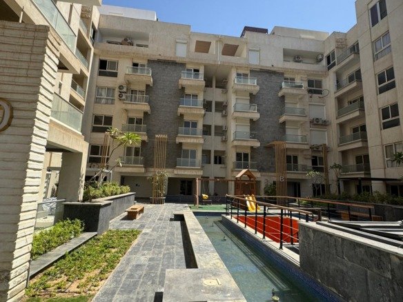 Landscaped residential courtyard, apartment for sale in Mountain View iCity Club Park, New Cairo | الساحة السكنية واللاندسكيب، شقة للبيع في ماونتن فيو إي سيتي كلوب بارك، القاهرة الجديدة