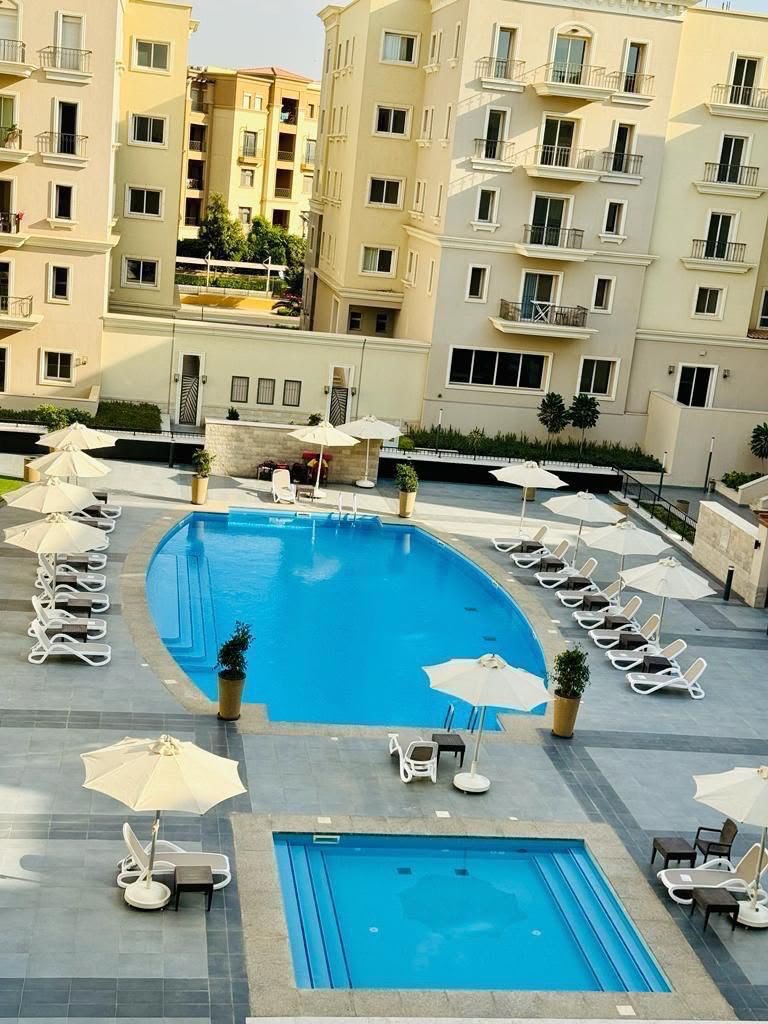 10-mivida-boulevard-apartment-rent-328-00 Swimming pool and landscaped courtyard view, apartment for rent in Mivida Boulevard, New Cairo | إطلالة حمام السباحة واللاندسكيب، شقة للإيجار في ميفيدا البوليفارد، القاهرة الجديدة