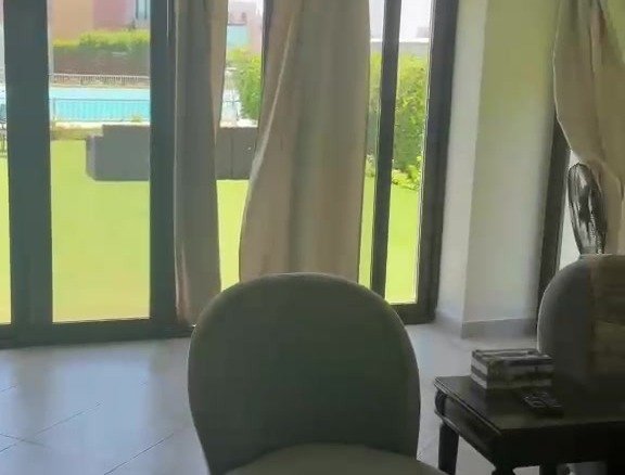 Lagoon and garden view through reception doors, villa for rent in Marassi Blanca 1, North Coast | إطلالة اللاجون والحديقة من أبواب الريسيبشن، فيلا للإيجار في مراسي بلانكا 1، الساحل الشمالي