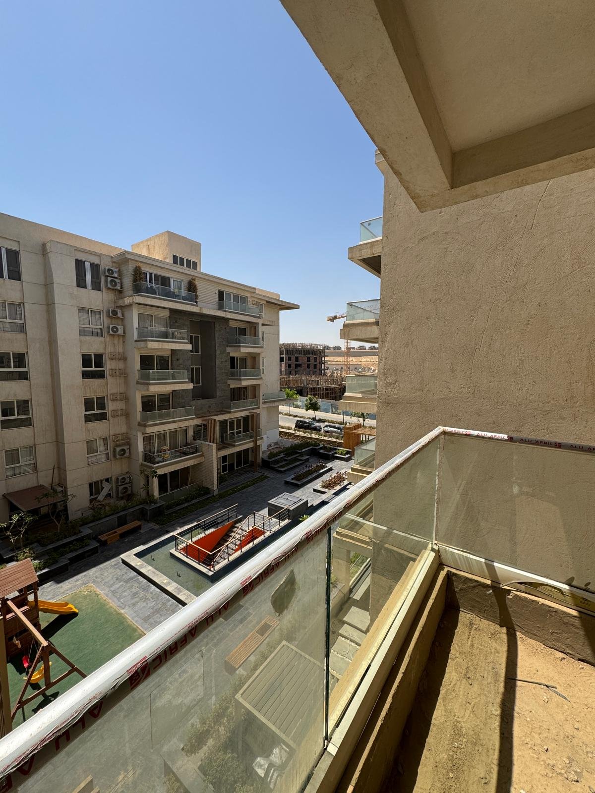 11-icity-clubpark-apartment-sale-349-01 Terrace and courtyard view, apartment for sale in Mountain View iCity Club Park, New Cairo | تراس وفيو الساحة، شقة للبيع في ماونتن فيو إي سيتي كلوب بارك، القاهرة الجديدة