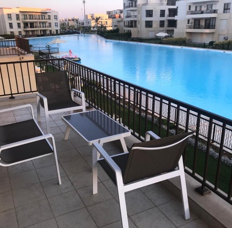 Lagoon-view terrace with outdoor seating, chalet for sale in Marassi Blanca, North Coast | تراس يطل على اللاجون مع جلسة خارجية، شاليه للبيع في مراسي بلانكا، الساحل الشمالي