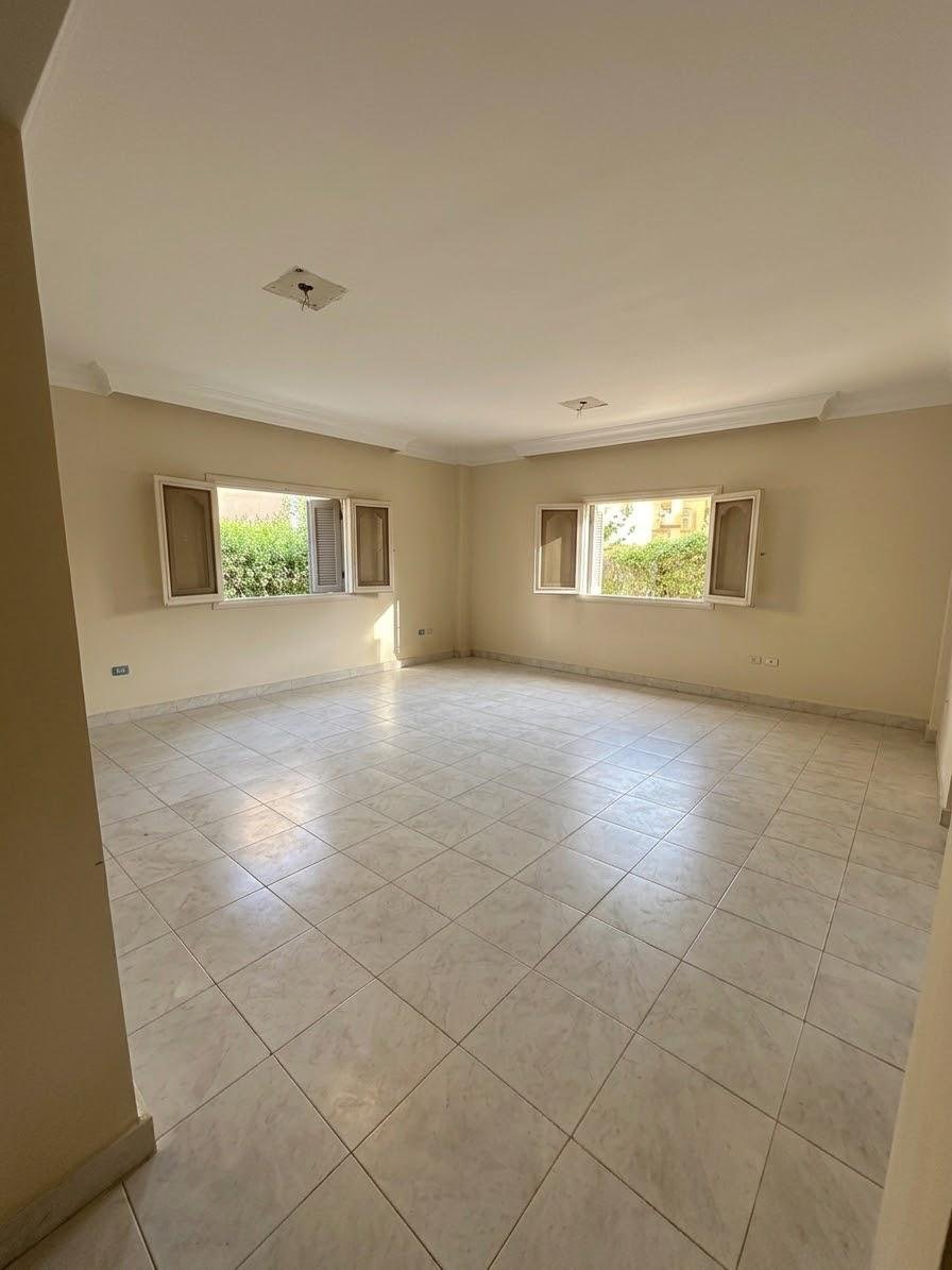 Empty room with a glossy tile floor seen from the door - apartment in Sahafeen Compound, New Cairo