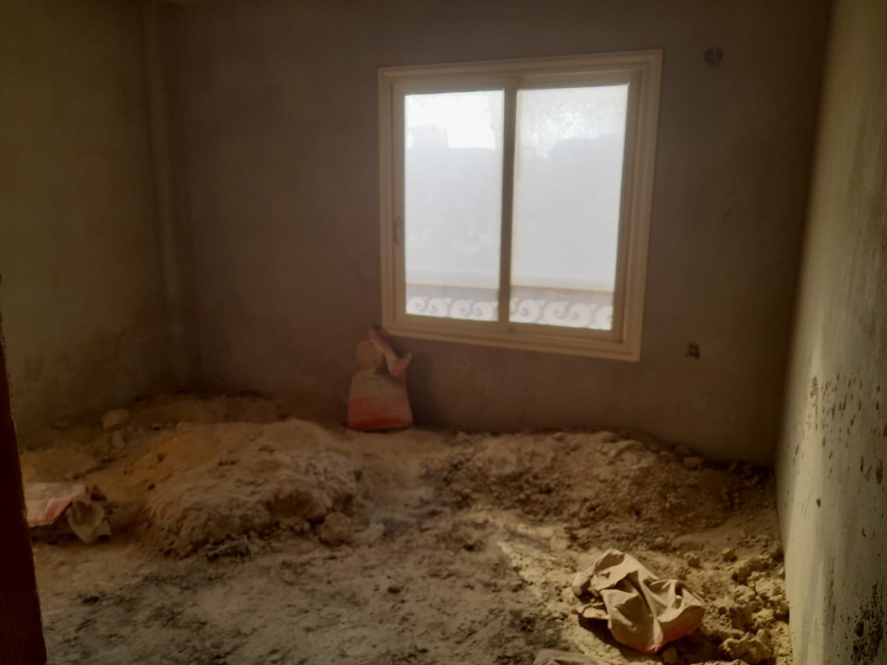 Rough room with a window and a pile of sand - penthouse in Green House, 5th Settlement