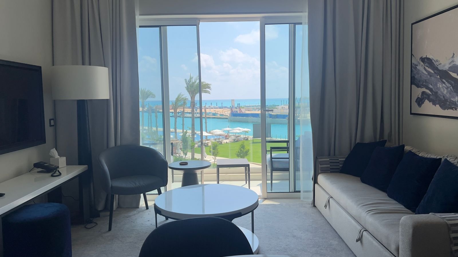 Sofa and coffee table beside balcony doors in Marassi, North Coast