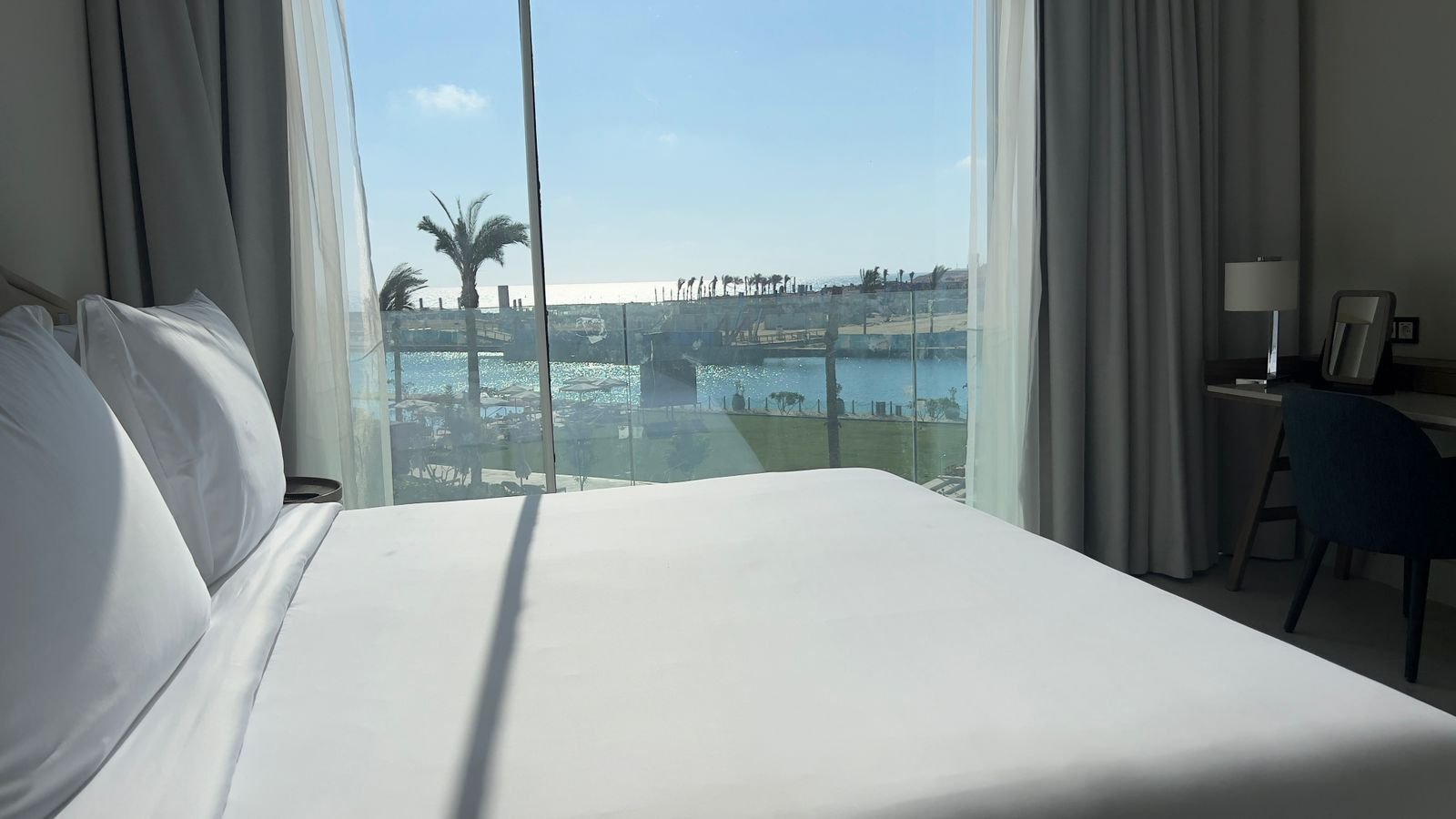 Bed beside a window overlooking the water in Marassi, North Coast