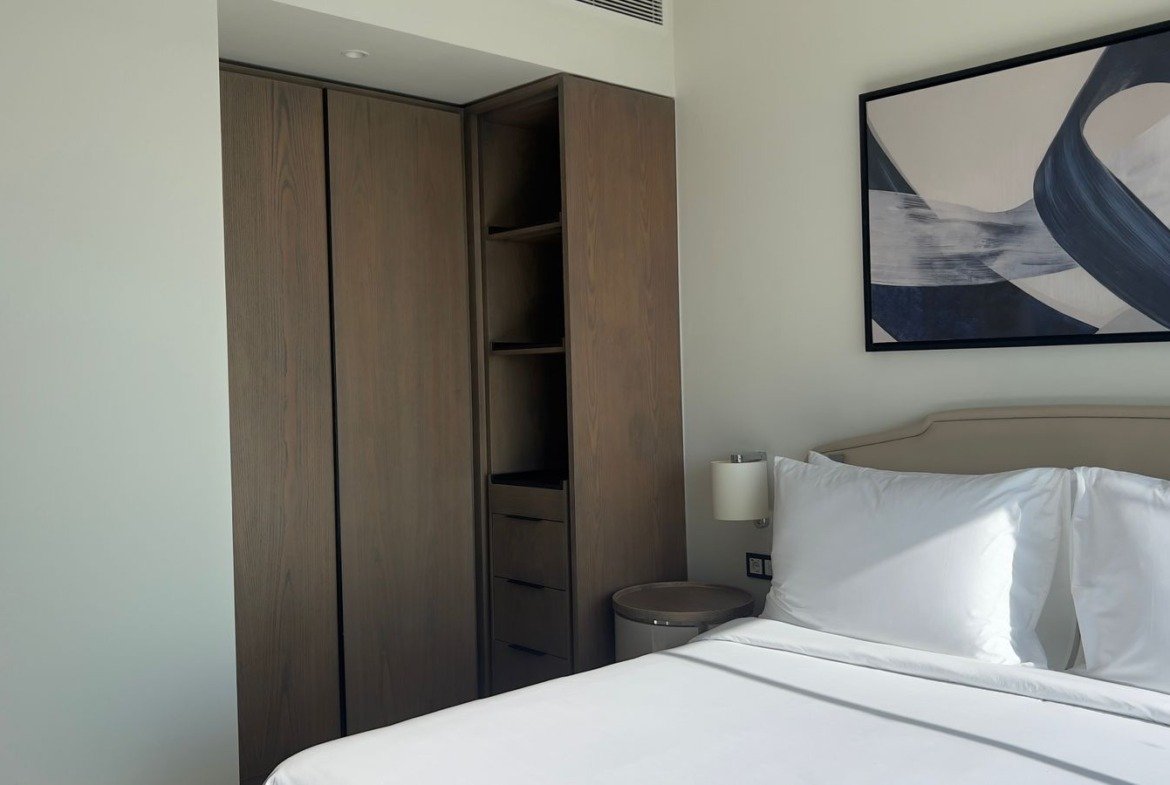 Bed beneath geometric wall artwork in Marassi, North Coast