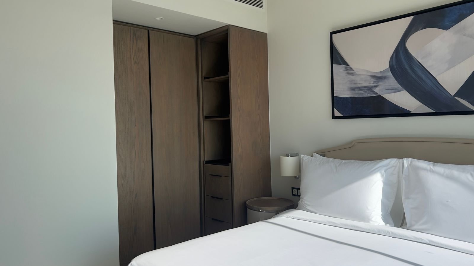 Bed beneath geometric wall artwork in Marassi, North Coast
