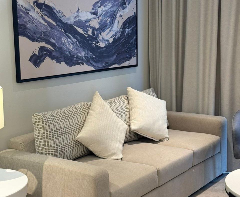 Sofa beneath framed artwork in Marassi, North Coast