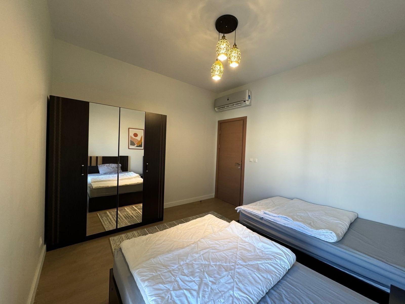 19-mivida-boulevard-apartment-rent-328-09 Twin bedroom and wardrobe, apartment for rent in Mivida Boulevard, New Cairo | غرفة نوم بسريرين وخزانة، شقة للإيجار في ميفيدا البوليفارد، القاهرة الجديدة