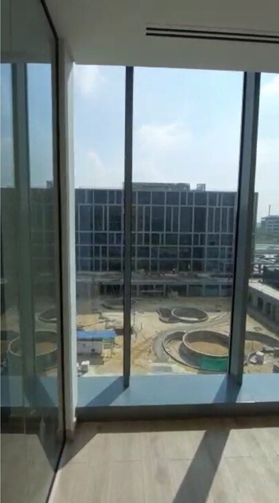 Glass wall with a view of the construction site and neighbouring blocks - office in Cairo Festival City, New Cairo