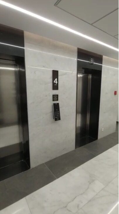 Elevator doors with a light stone wall - office in Cairo Festival City, New Cairo