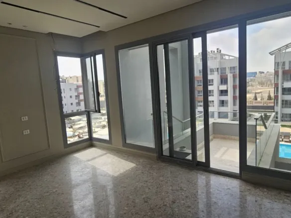 Empty room opening onto a balcony in JW Marriott, Mirage City