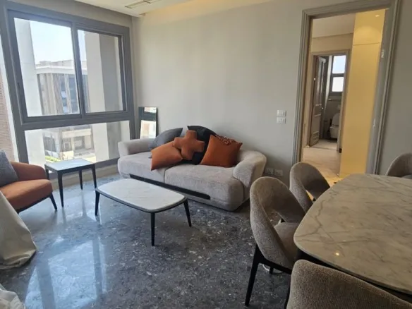 Living room beside balcony doors in JW Marriott, Mirage City