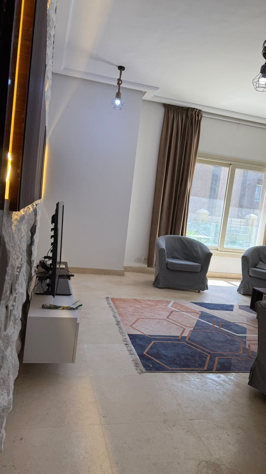 Living room by balcony, The Village apartment for sale | معيشة بجوار البلكونة، شقة للبيع في ذا فيلدج