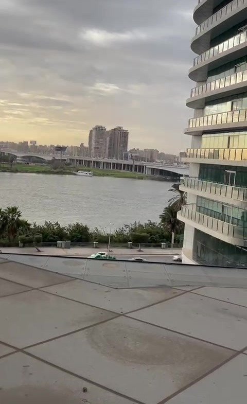 Balcony with a river view between buildings - hotel apartment in Marassi