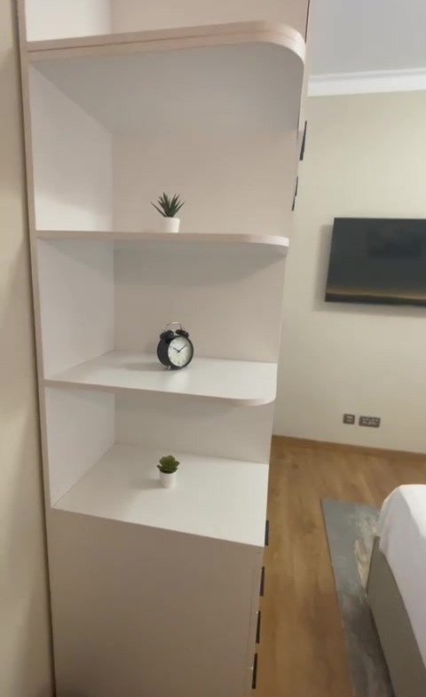 White shelving unit beside a bedroom wall - hotel apartment in Marassi