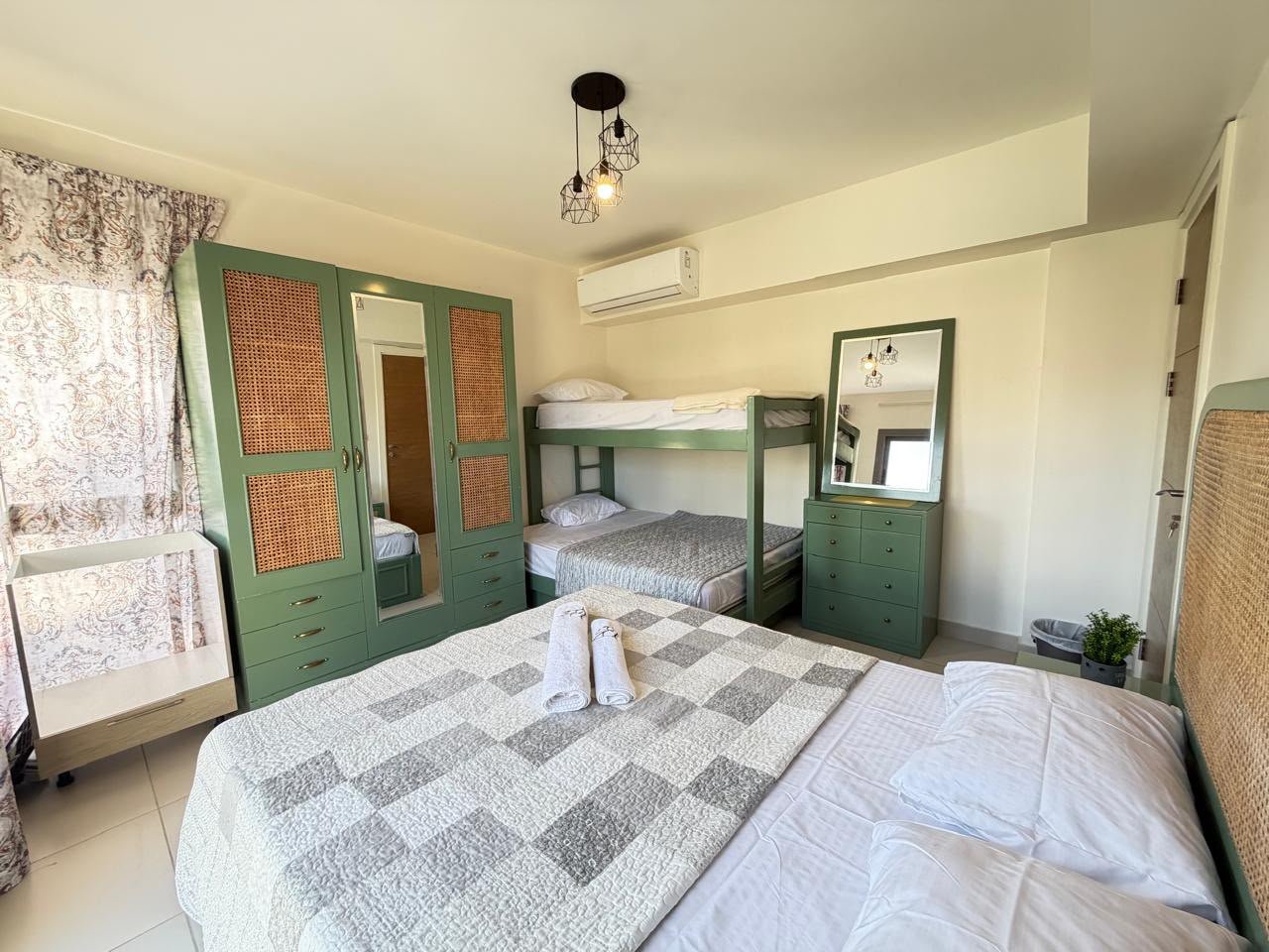 50-marassi-marina-2-304-03 Bedroom with double bed and bunk beds, chalet for rent in Marassi Marina 2, North Coast | غرفة نوم بسرير مزدوج وسرير دورين، شاليه للإيجار في مراسي مارينا 2، الساحل الشمالي