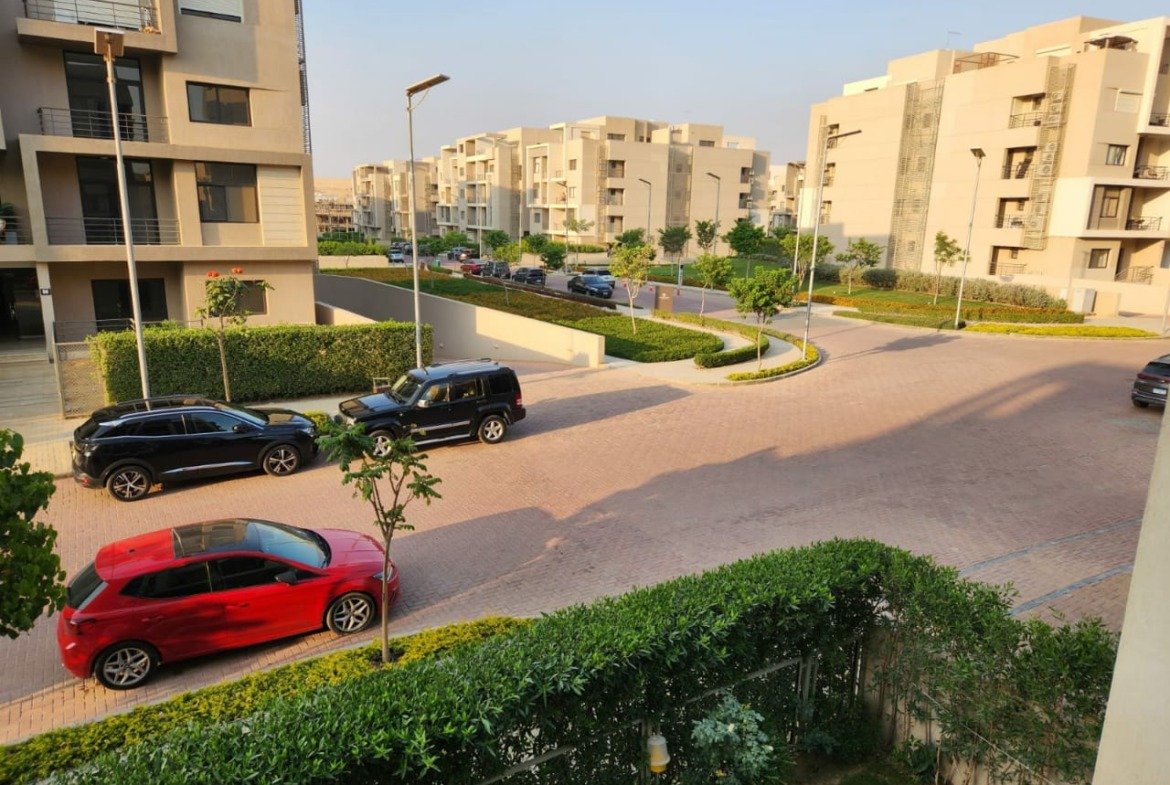 Compound street and parked cars seen from the balcony - apartment in Golden Square, Fifth Square, New Cairo