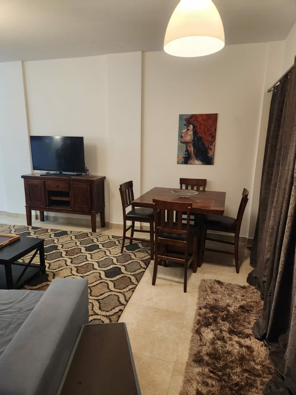 Fifth Square apartment 514-04 Living room with dining table and television - apartment in Golden Square, Fifth Square, New Cairo